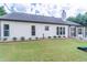 A level backyard featuring green lawn, tasteful landscaping, and partial view of a playset at 220 Chandler Ct, Sugar Hill, GA 30518
