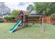 Backyard featuring lush green lawn and a wooden playset for outdoor fun at 220 Chandler Ct, Sugar Hill, GA 30518