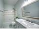 Fresh bathroom with tub, sleek vanity with marble top, and decorative mirror at 220 Chandler Ct, Sugar Hill, GA 30518