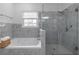 Bathroom features a glass-enclosed shower and jacuzzi tub at 220 Chandler Ct, Sugar Hill, GA 30518