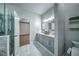 Upscale bathroom features dual sinks, a glass shower, and stylish marble floors at 220 Chandler Ct, Sugar Hill, GA 30518