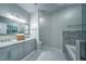 Elegant bathroom features double vanity, marble floors, and a separate tub and shower at 220 Chandler Ct, Sugar Hill, GA 30518