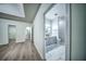Hallway view of a renovated bathroom with a double sink vanity and marble floors at 220 Chandler Ct, Sugar Hill, GA 30518