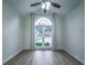 Sunny bedroom showcasing a large window, fan, and stylish gray wood flooring at 220 Chandler Ct, Sugar Hill, GA 30518