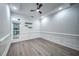 Bedroom with hardwood floors, custom trim, tray ceiling, recessed lights, and large windows at 220 Chandler Ct, Sugar Hill, GA 30518