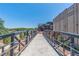 Picturesque pedestrian bridge with steel railings connecting buildings under a clear blue sky at 220 Chandler Ct, Sugar Hill, GA 30518