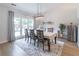 Bright dining room features large windows, modern light fixture, and neutral decor at 220 Chandler Ct, Sugar Hill, GA 30518