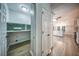 Hallway showcasing hardwood flooring, with a view of the bright kitchen and laundry room at 220 Chandler Ct, Sugar Hill, GA 30518