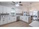 Bright kitchen features white cabinets, stone countertops, and stainless steel appliances at 220 Chandler Ct, Sugar Hill, GA 30518
