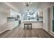 Modern kitchen with sleek appliances, island, and adjoining dining space at 220 Chandler Ct, Sugar Hill, GA 30518