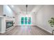 Open living room featuring a fireplace, large windows and updated flooring at 220 Chandler Ct, Sugar Hill, GA 30518