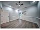 Cozy living room with chair railing, recessed lighting, floating shelves, and wood-look floors at 220 Chandler Ct, Sugar Hill, GA 30518