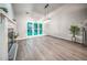 Spacious living room featuring hardwood floors, a fireplace, and large windows overlooking the backyard at 220 Chandler Ct, Sugar Hill, GA 30518