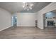 Bright living room boasts stylish lighting, vaulted ceilings, and attractive gray wood floors at 220 Chandler Ct, Sugar Hill, GA 30518