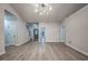 Inviting living room with modern lighting, sleek gray wood flooring, and an open layout at 220 Chandler Ct, Sugar Hill, GA 30518