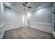Spacious living room with modern trim work, floating shelves, recessed lights, and wood-look flooring at 220 Chandler Ct, Sugar Hill, GA 30518