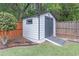 Backyard shed featuring a ramp entrance, neutral paint scheme and tasteful landscaping at 220 Chandler Ct, Sugar Hill, GA 30518