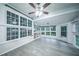 Sunroom features hardwood floors, white trim, and an abundance of large windows at 220 Chandler Ct, Sugar Hill, GA 30518