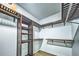 Organized walk-in closet with custom shelving and laminate floor at 220 Chandler Ct, Sugar Hill, GA 30518
