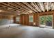 Unfinished basement featuring open framework, lighting, and a sliding door to the yard at 338 Boundless Ln, Canton, GA 30114