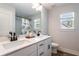 Bright bathroom with dual sinks, white cabinets, and a stylish, modern aesthetic at 338 Boundless Ln, Canton, GA 30114