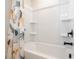 bath featuring a tub with a fun animal themed shower curtain and built-in shelving at 338 Boundless Ln, Canton, GA 30114