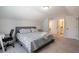 Well-lit bedroom with a patterned bedspread and office desk, bathed in natural light at 338 Boundless Ln, Canton, GA 30114