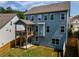 Rear exterior view of a two-story home with a deck, patio, and fenced backyard at 338 Boundless Ln, Canton, GA 30114