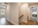 Bright hallway with hardwood floors leads to a bedroom and staircase at 338 Boundless Ln, Canton, GA 30114