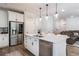 Spacious kitchen with white cabinets, stainless steel appliances, island, and hardwood flooring at 338 Boundless Ln, Canton, GA 30114