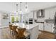 Modern kitchen with white cabinetry, stainless steel appliances, and a large center island with seating at 338 Boundless Ln, Canton, GA 30114