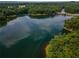 Aerial shot showcasing a tranquil lake surrounded by lush green trees and vegetation at 338 Boundless Ln, Canton, GA 30114