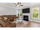 Inviting living room with cozy seating, a fireplace, and large windows providing ample natural light at 338 Boundless Ln, Canton, GA 30114