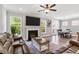 Bright living room with a fireplace, hardwood floors, and plenty of natural light from the surrounding windows at 338 Boundless Ln, Canton, GA 30114
