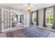 Beautiful bedroom features chandelier lighting, french doors, and large windows with views at 338 Boundless Ln, Canton, GA 30114