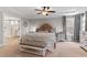 Cozy main bedroom with tray ceilings, a luxurious bed, and an en-suite bathroom at 338 Boundless Ln, Canton, GA 30114