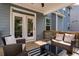 Relaxing outdoor porch with wicker furniture, a striped rug, and a view of the surrounding greenery at 338 Boundless Ln, Canton, GA 30114