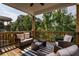 Inviting back porch with comfortable seating, a coffee table, and a serene view of the wooded area at 338 Boundless Ln, Canton, GA 30114