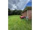 View of the property's grassy backyard, as well as the home's exterior brick facade at 6192 Meadowbrook Dr, Norcross, GA 30093