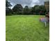 This property features a large, grassy backyard with mature trees and a satellite dish at 6192 Meadowbrook Dr, Norcross, GA 30093
