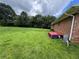 View of the property's spacious backyard with trees, a home exterior, and a satellite dish at 6192 Meadowbrook Dr, Norcross, GA 30093
