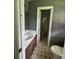 This bathroom features a single sink vanity, tile flooring, and a shower-tub combo at 6192 Meadowbrook Dr, Norcross, GA 30093