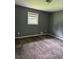 This bedroom features patterned carpeting, a window, neutral walls and overhead lighting at 6192 Meadowbrook Dr, Norcross, GA 30093