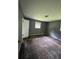 Bedroom with patterned carpeting, neutral walls, and a single window for natural light at 6192 Meadowbrook Dr, Norcross, GA 30093