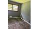 Bedroom with patterned carpeting, a window overlooking greenery, and light-grey walls at 6192 Meadowbrook Dr, Norcross, GA 30093
