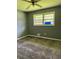 Bedroom with patterned carpeting, a window overlooking greenery, and light-grey walls at 6192 Meadowbrook Dr, Norcross, GA 30093