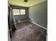 Bedroom with patterned carpeting, a window overlooking greenery, and light-grey walls at 6192 Meadowbrook Dr, Norcross, GA 30093