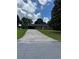 Charming single-story brick home with a long driveway and attached carport, nestled among mature trees at 6192 Meadowbrook Dr, Norcross, GA 30093