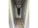 Hallway with doors on either side features gray walls, white trim and gray wood-look flooring with overhead lighting at 6192 Meadowbrook Dr, Norcross, GA 30093