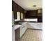 Kitchen featuring white cabinets, vintage appliances, and tile flooring at 6192 Meadowbrook Dr, Norcross, GA 30093